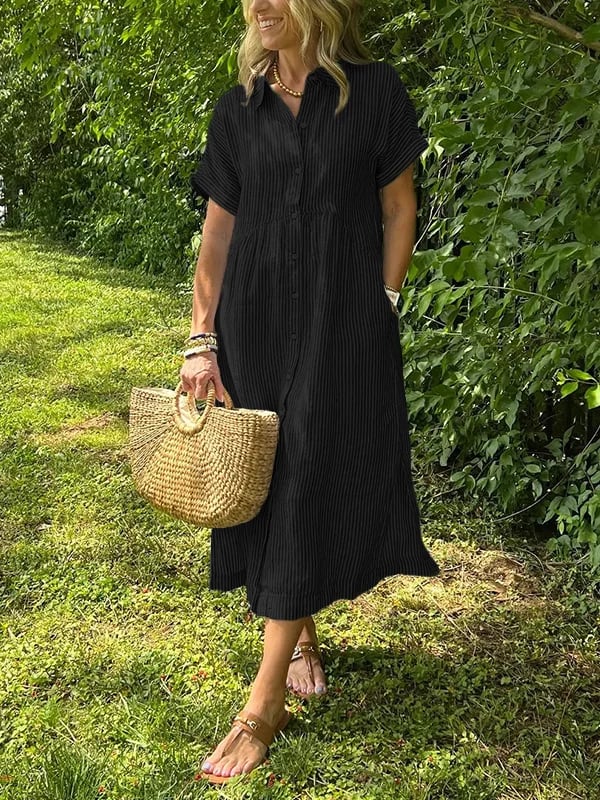 Side view of relaxed fit striped midi dress showing gathered waist seam and drop shoulder sleeves