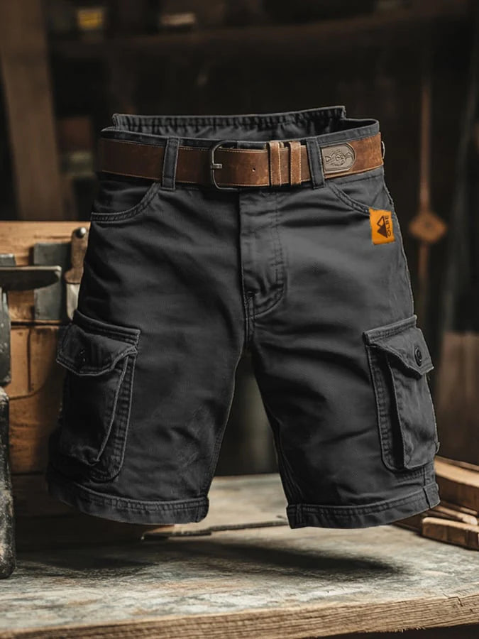 Close-up of cargo shorts waistband with belt loops and button closure paired with a brown belt