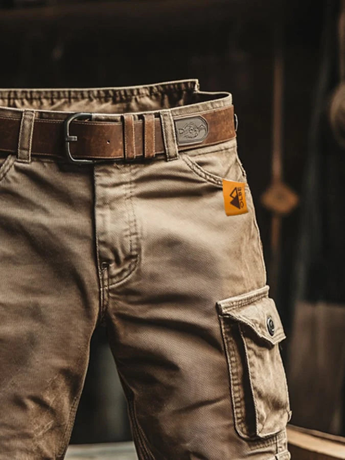 Men's cargo shorts laid flat displaying straight-leg silhouette and mid-thigh length with functional pockets