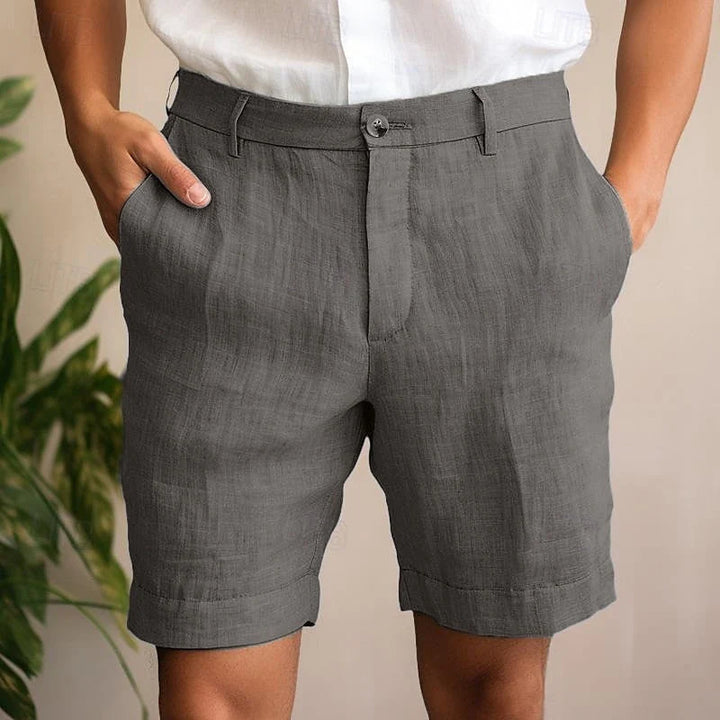 Close-up view of men's chino shorts showing structured woven fabric and relaxed fit through the leg