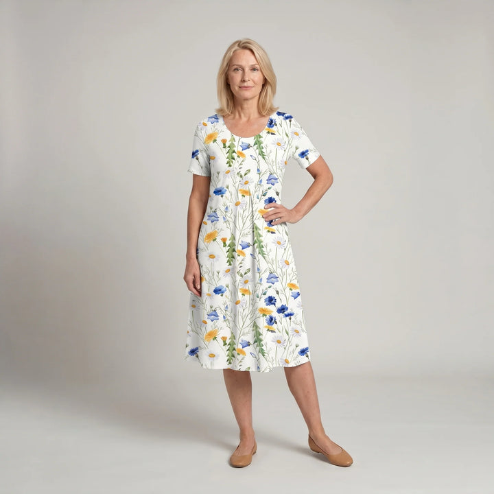 Woman wearing floral midi dress with A-line silhouette and short sleeves in white print