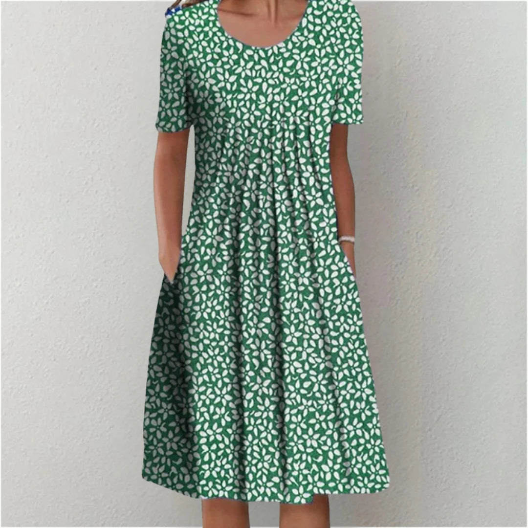 Side profile of floral midi dress showing pleated bodice and waist drape