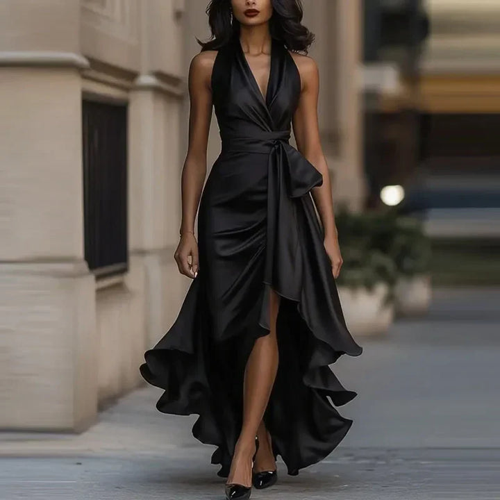 Side view of satin maxi dress featuring statement waist tie detail and flowing asymmetric hemline