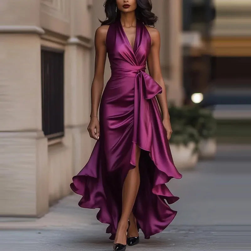 Back view of halter neck maxi dress showcasing open back design and cascading high-low skirt