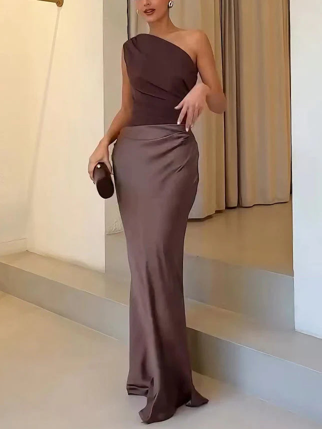 Back view of one shoulder pleated party maxi dress showing smooth silhouette and floor length hem