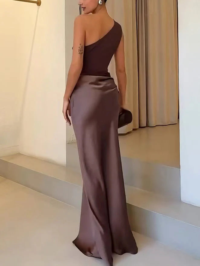 Woman styled in one shoulder pleated party maxi dress for wedding or gala event