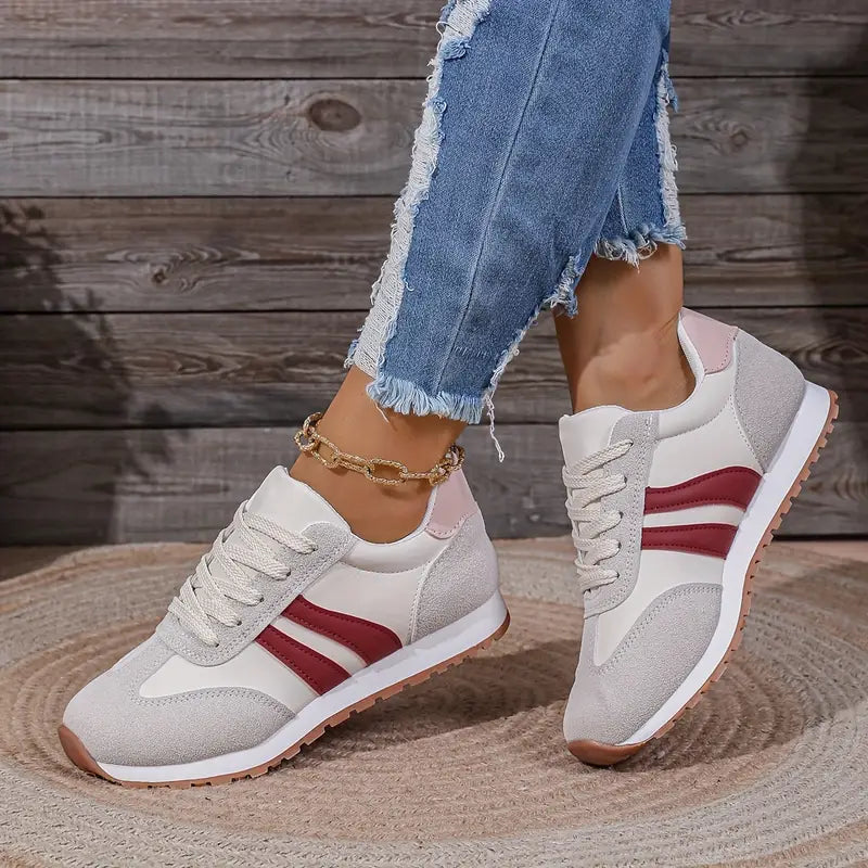 Side view of retro-inspired sneakers with lace-up closure and padded collar for ankle support