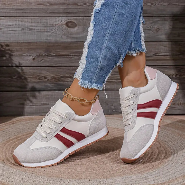 Side view of retro-inspired sneakers with lace-up closure and padded collar for ankle support