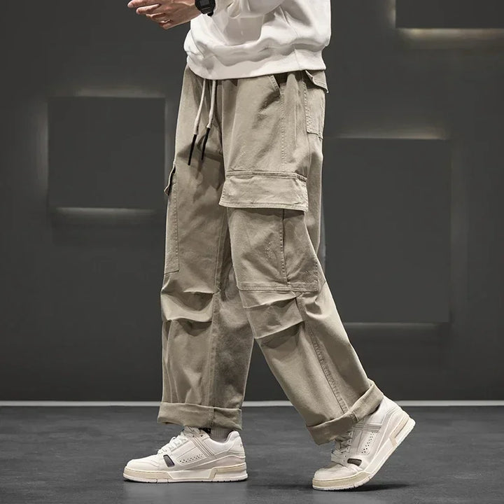 Men's wide leg cargo pants styled with white sneakers for casual streetwear look