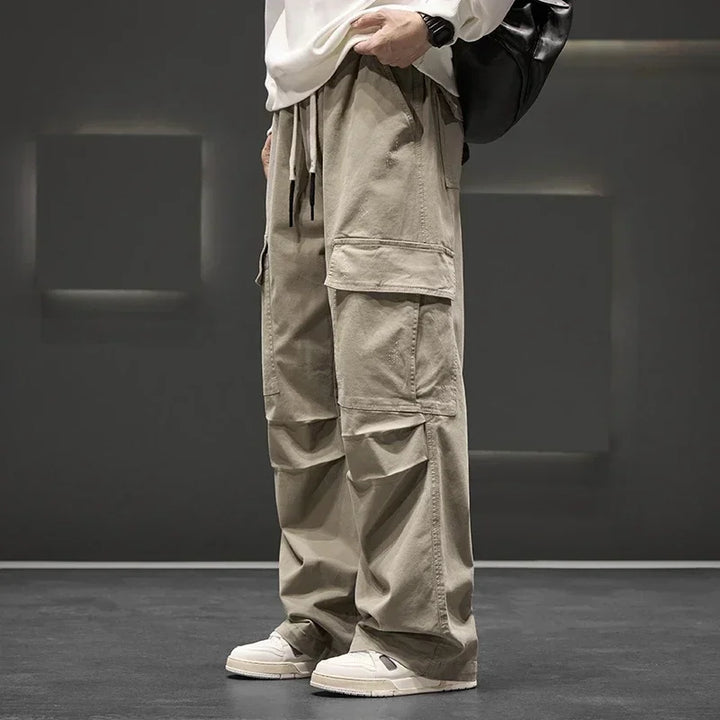 Close-up of cargo pant utility pockets with flap closure and reinforced stitching