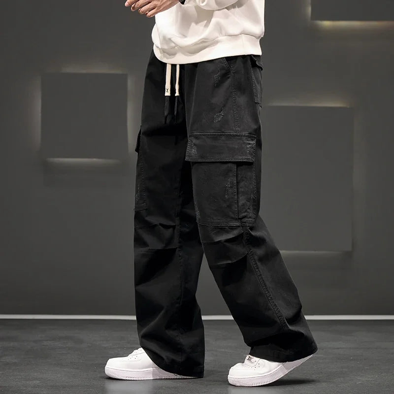 Detail shot of cuffed hem on men's wide leg cargo pants in olive green
