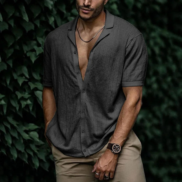 Close-up of textured fabric and button details on men's short sleeve shirt