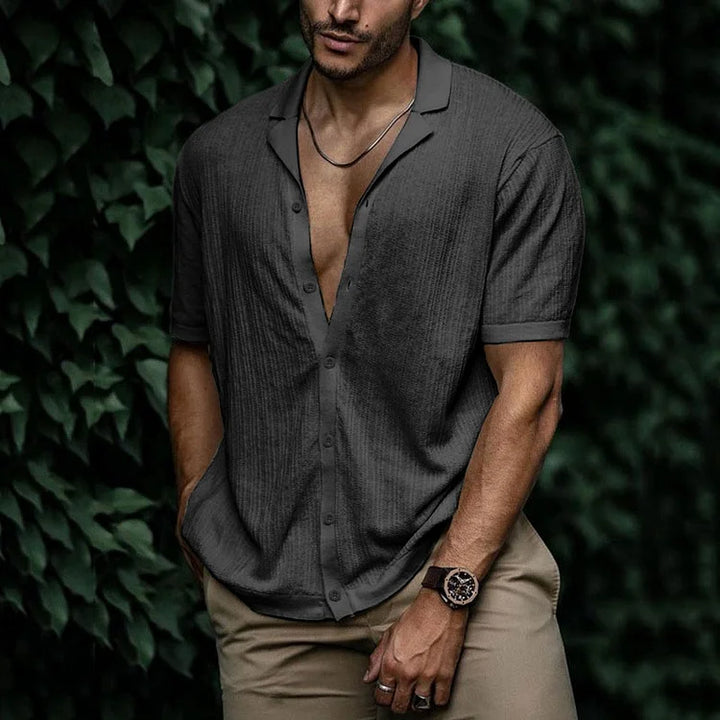 Close-up of textured fabric and button details on men's short sleeve shirt