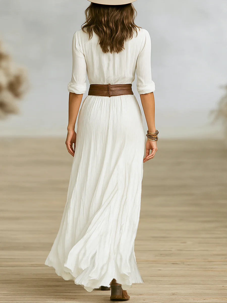 Model wearing button front belted maxi dress demonstrating adjustable roll-tab sleeves and flowing movement