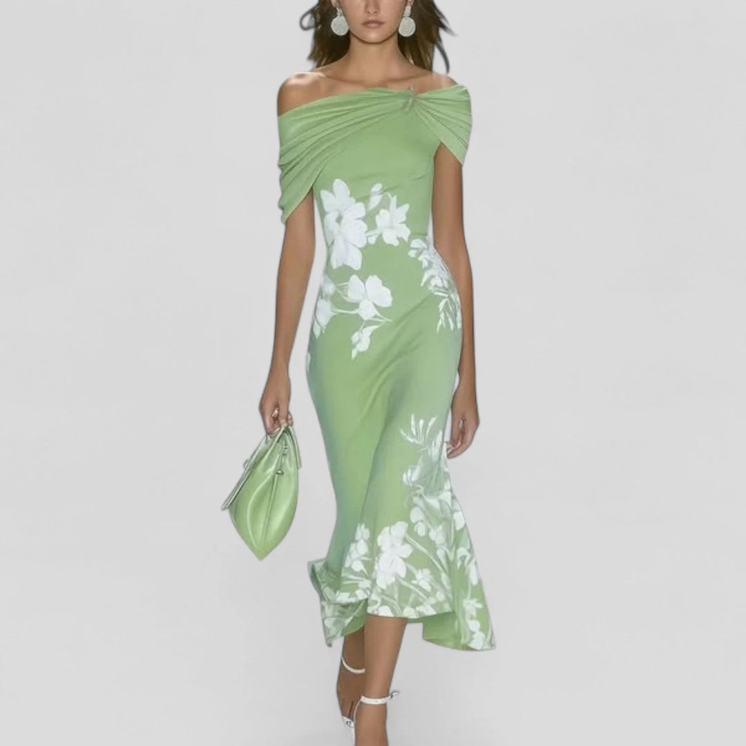 Charlotte wearing an Elegant Midi Dress with off-shoulder neckline and white floral print on sage green fabric