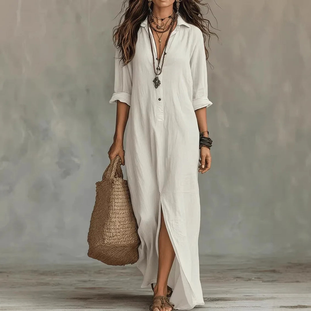 Woman wearing a white kaftan linen long shirt dress with collared neckline and ankle-length hem in a relaxed fit