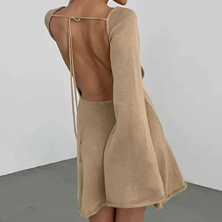 Detail of flared cuff sleeves on long-sleeve mini dress with wide neckline