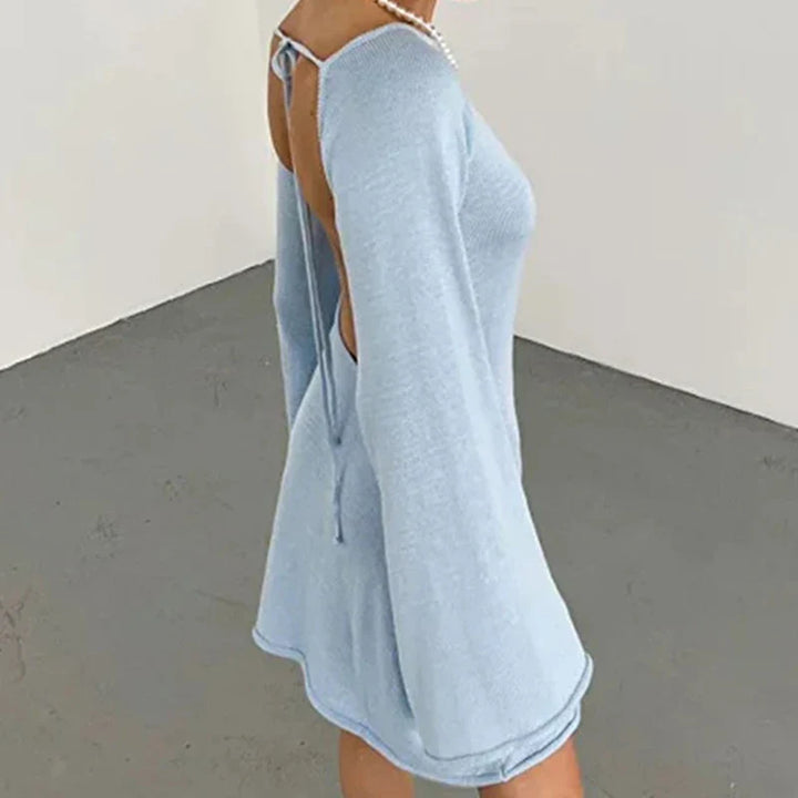 Back view of streamlined mini dress showing wide neckline and smooth hemline