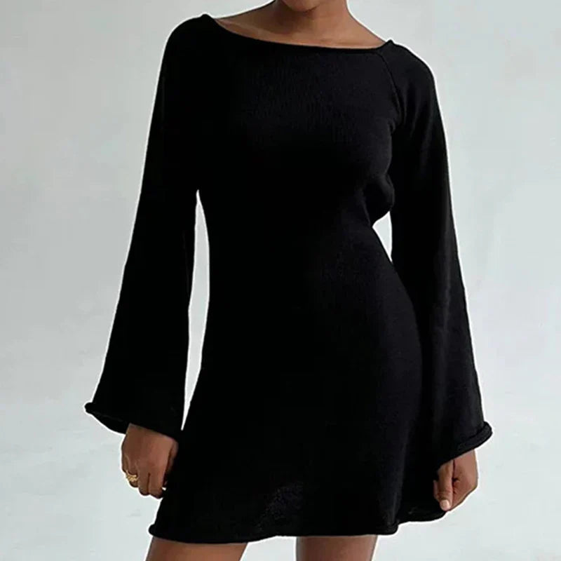Woman styling long-sleeve mini dress with flared cuffs for casual occasion