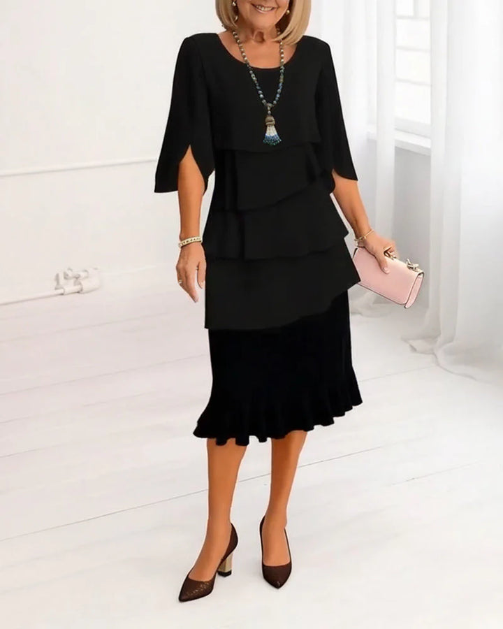 Close-up view of elegant midi dress showing ruffle tier details and A-line silhouette