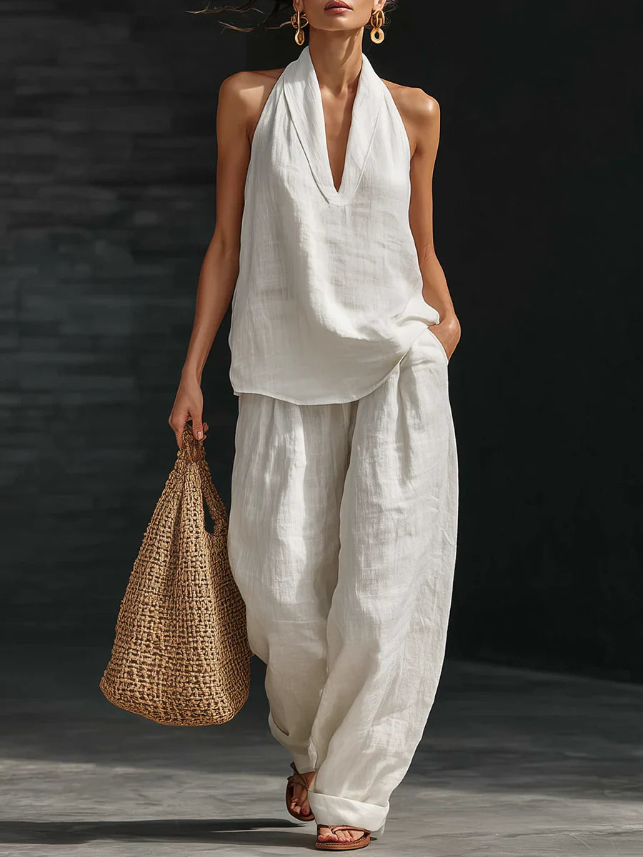 Women's halter top wide leg pants set in white with deep V-neck and flowing silhouette