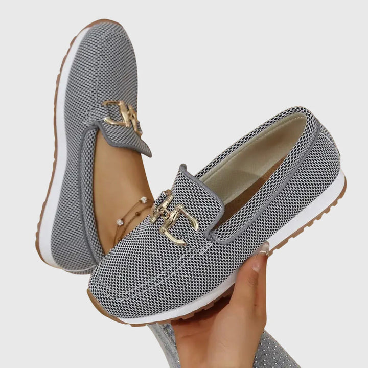 Women's blue orthopedic loafers from above showing slip-on opening and structured vamp with hardware