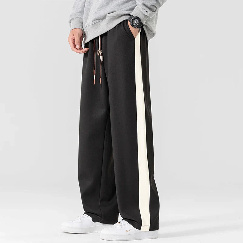 Men's wide leg side stripe sweatpants in black with contrasting white stripe detail