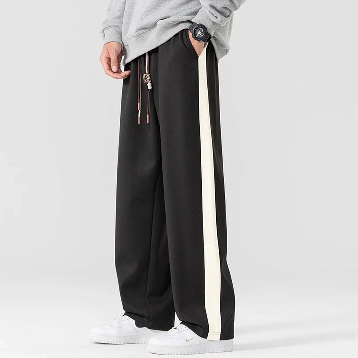 Men's wide leg side stripe sweatpants in black with contrasting white stripe detail