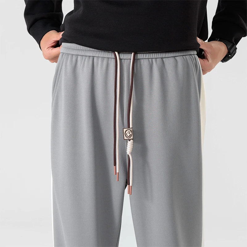 Close-up of elastic drawstring waistband on men's wide leg sweatpants with adjustable closure