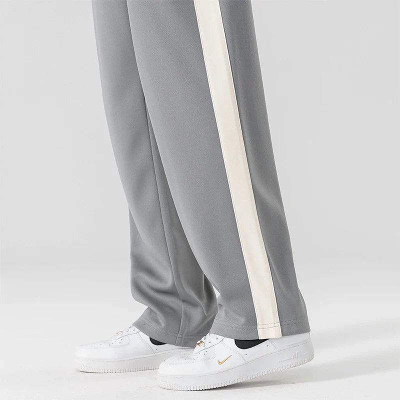 Detail shot of contrasting side stripe running down men's wide leg sweatpants