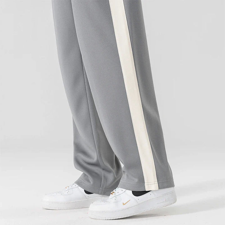 Detail shot of contrasting side stripe running down men's wide leg sweatpants