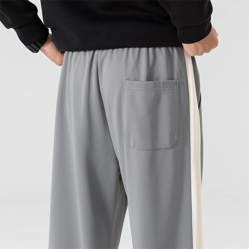 Full length view of men's relaxed fit sweatpants with side stripe and roomy silhouette