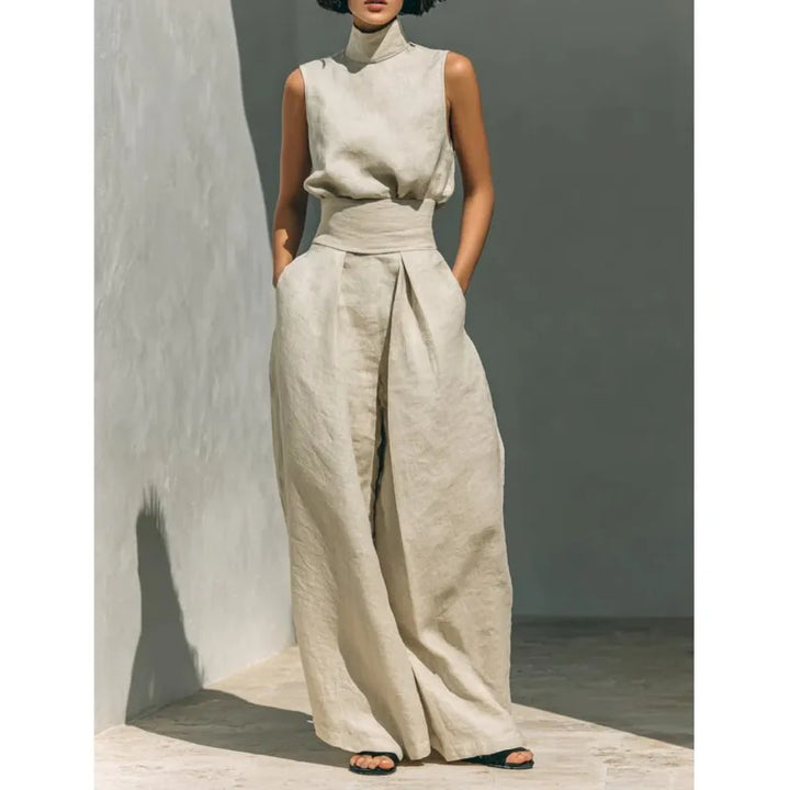 High waist jumpsuit with sleeveless draped top and wide leg trousers in neutral beige tone