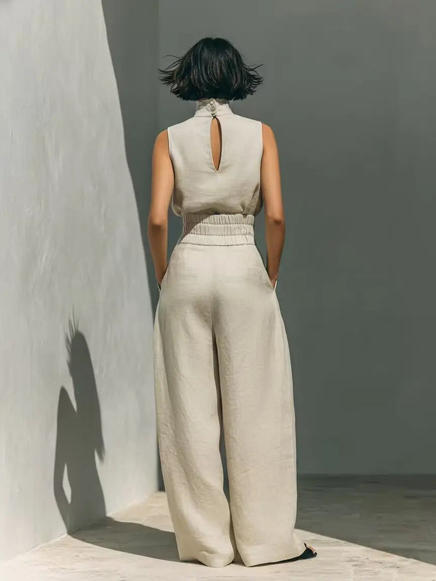 Side view of high waist jumpsuit showing cinched waist detail and flowing wide leg silhouette