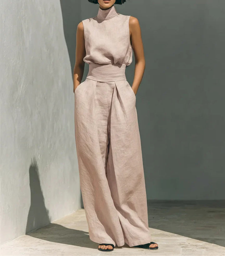 Back view of sleeveless high waist jumpsuit with stand collar and relaxed fit