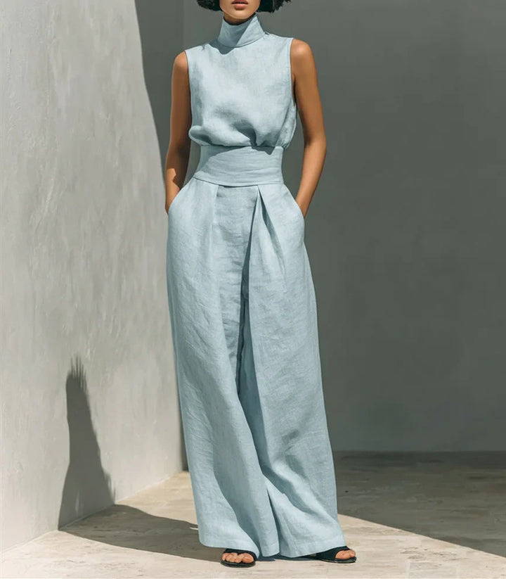 Detail shot of cinched waist and pleated wide leg trousers on high waist jumpsuit