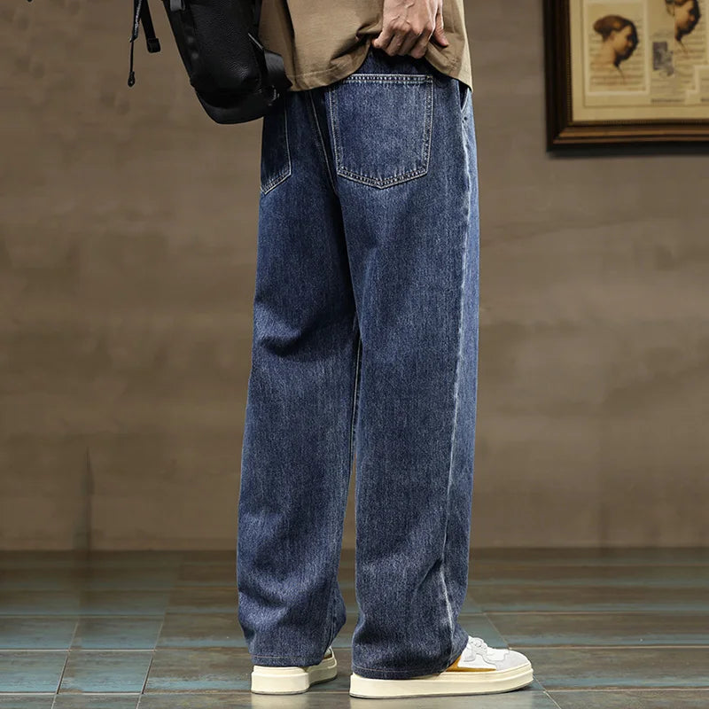 Side view of men's wide leg jeans showing relaxed straight leg silhouette and contrast drawcord detail