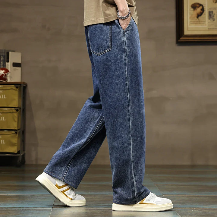 Close-up of adjustable drawstring waistband with tan cord and small hip patch on men's jeans