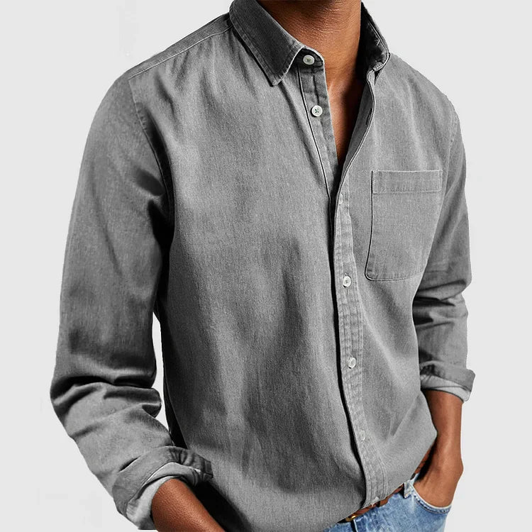Men's navy button-front shirt worn casually with jeans for everyday styling