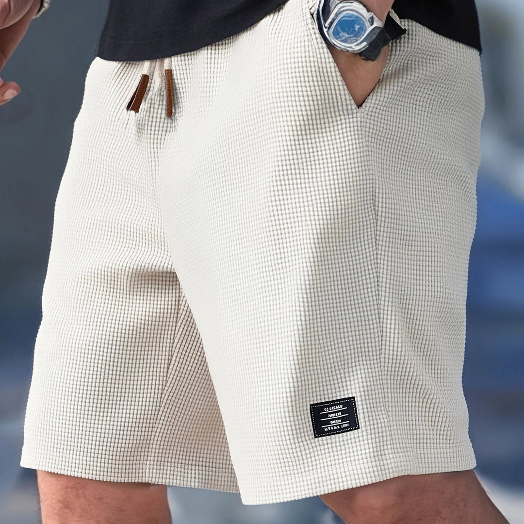 Men's relaxed fit chino shorts in textured waffle-knit fabric with elastic drawstring waist and side pockets