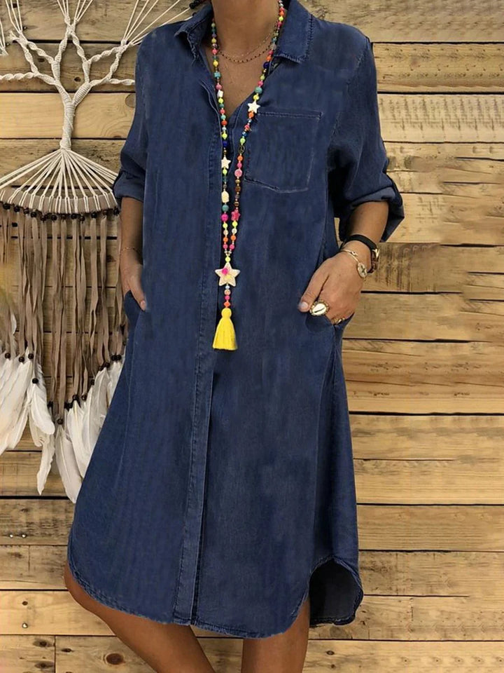 Side angle of relaxed fit Denim Shirt Dress with three-quarter sleeves and rounded hemline