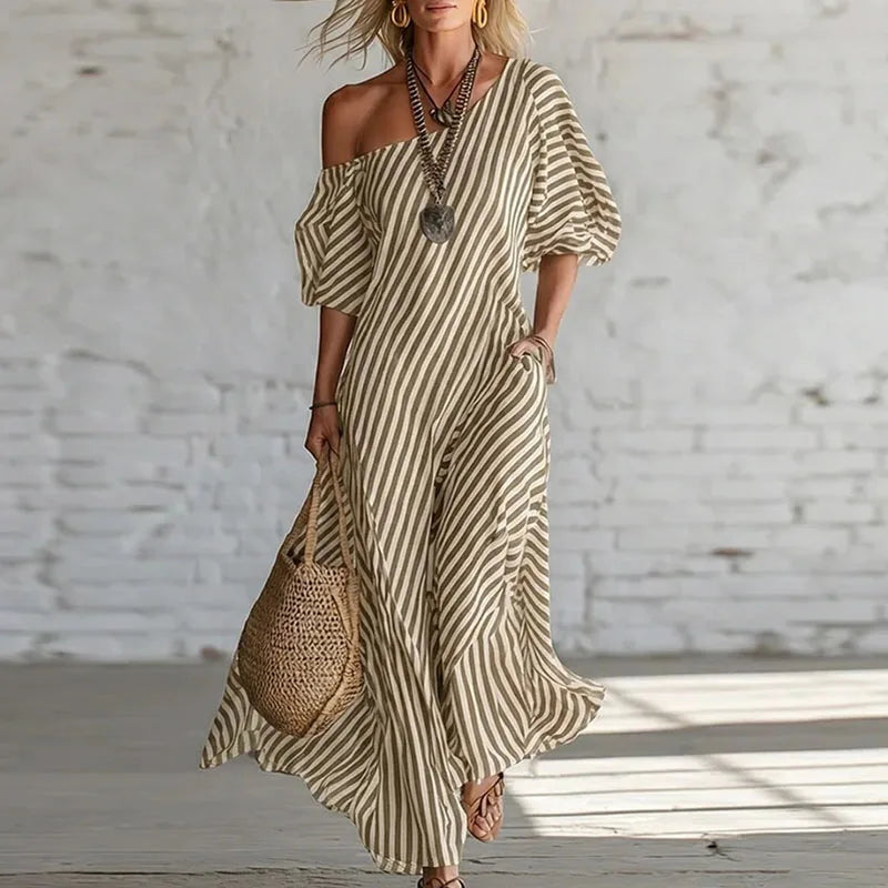 Detail of asymmetric one-shoulder neckline on puff sleeve maxi dress with vertical stripes