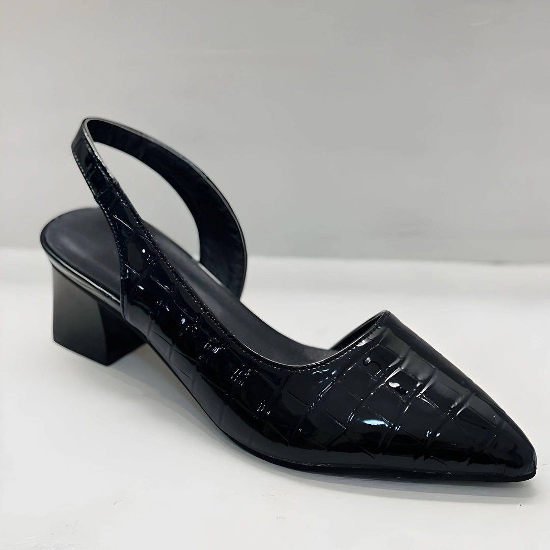 Side view of black slingback heels with arch support and cushioned insole design