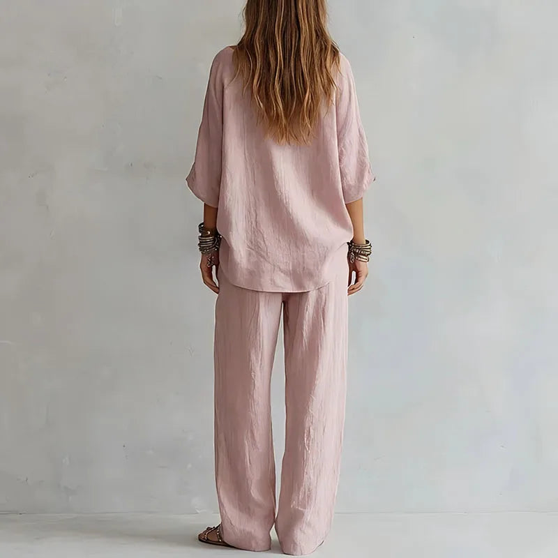 Close-up view of off shoulder top with three-quarter sleeves and flowing fabric drape