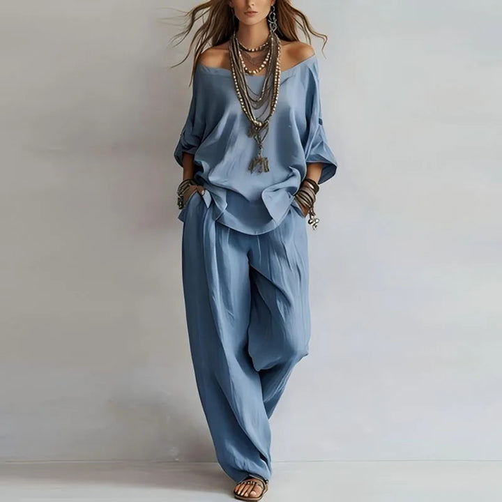 Full-length view of off shoulder co-ord set styled with statement jewelry and accessories