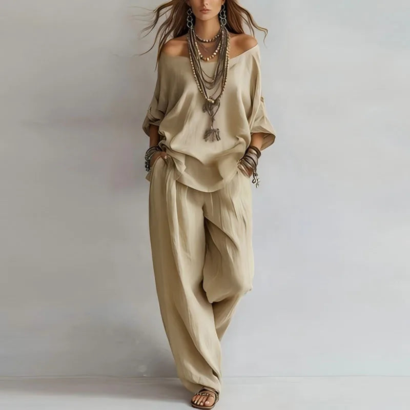 Woman styling off shoulder co-ord set with layered necklaces and bracelets for casual look