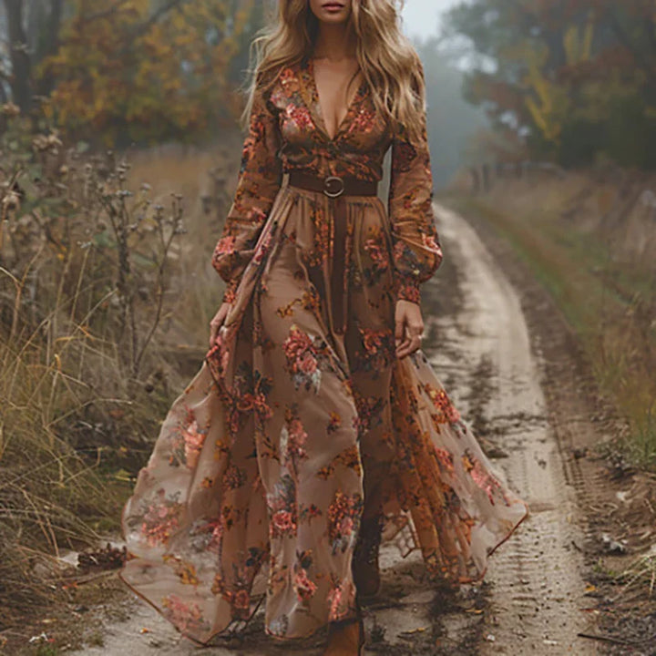 Close-up of tie waist and embroidered detail on flowing maxi dress with ruffle hem