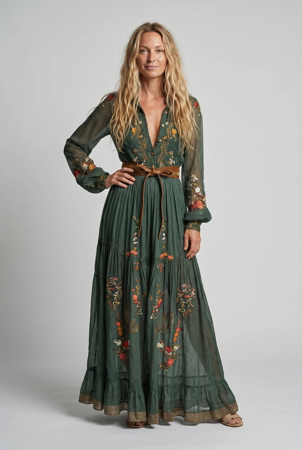 Side view of embroidered maxi dress showing tiered hem and flowing silhouette with tie waist