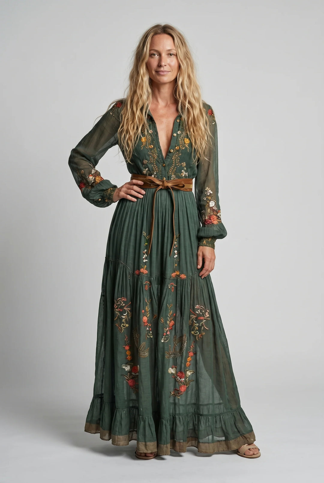 Side view of embroidered maxi dress showing tiered hem and flowing silhouette with tie waist