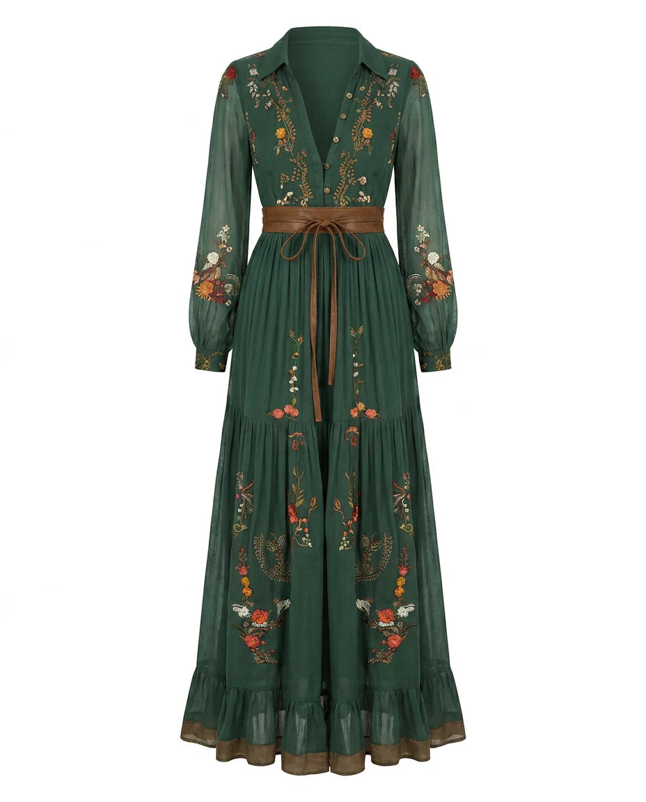 Detail of sheer balloon sleeves with floral embroidery and button cuffs on maxi dress